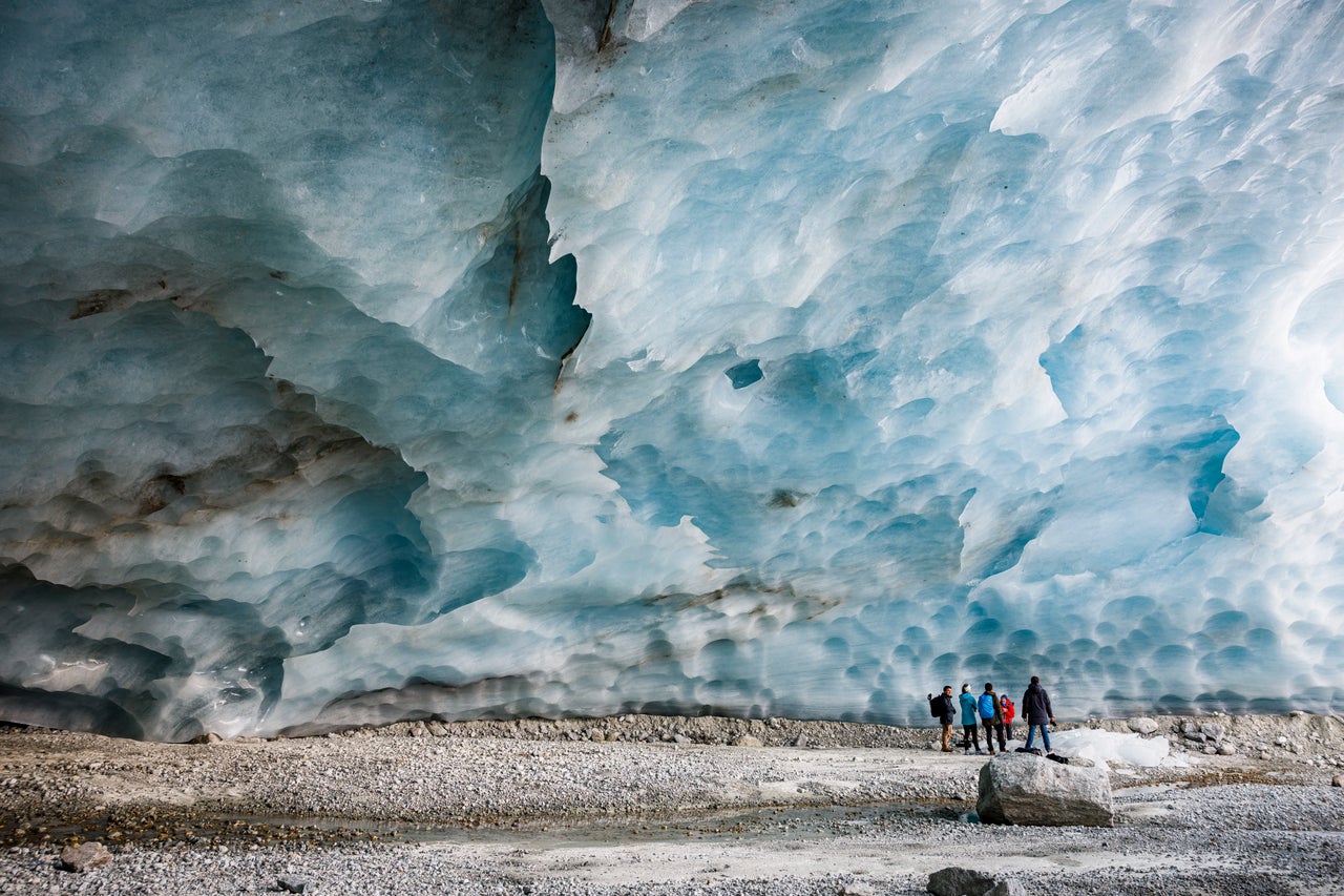 Hikers visit an ice cave formed at the end section of the Zinal Glacier, above the alpine village of Zinal, Switzerland, on Nov. 13.