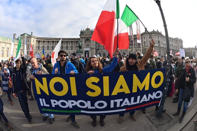Protesters stand with a sign with the inscription 
