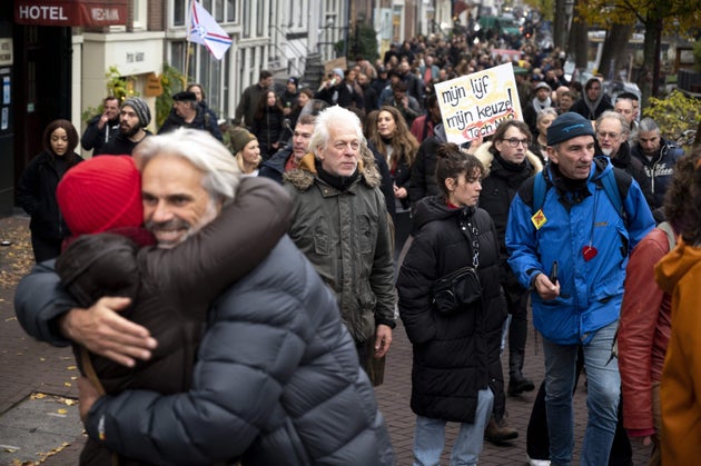 People march during a protest against the latest measures to fight the Covid-19 pandemic, despite the...