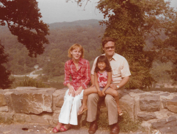 The author at age 5 with her parents in 1978.