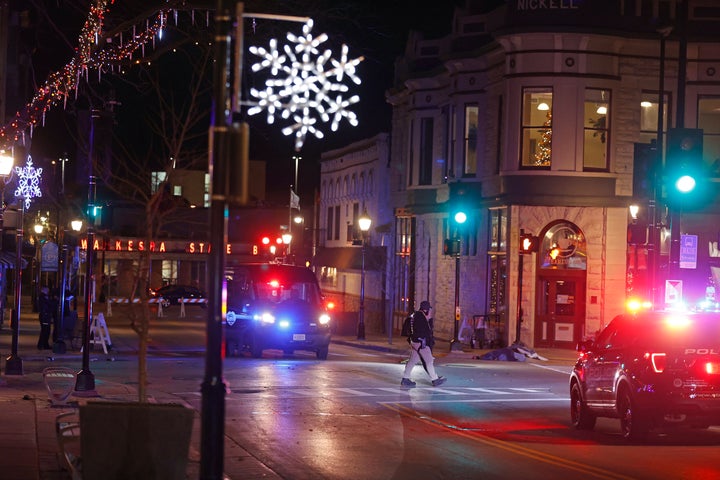 Police canvass the streets in downtown Waukesha, Wisconsin, after a vehicle plowed into a Christmas parade on Sunday.