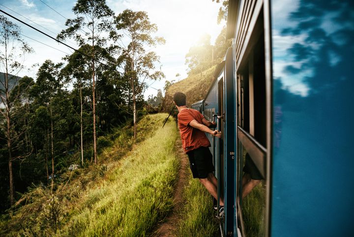 Taking in the scenery on a train ride in Sri Lanka as this young traveller heads to his next destination, photographed by Jonathan Sterz