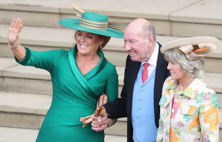 In this 2018 photo, Sarah, Duchess of York, stands with the parents of the groom, Nicola and George Brooksbank, as they wave off Princess Eugenie and her husband, Jack Brooksbank.