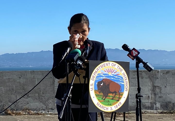 Interior Secretary Deb Haaland wipes a tear from her eye during remarks about progress made by Native Americans. She credited President Joe Biden for pursuing policies that empower tribes' self-determination.