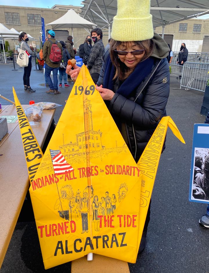 Akemi Yamane of Berkeley, California, holds a massive paper crane she made and illustrated with images of Native Americans occupying Alcatraz.