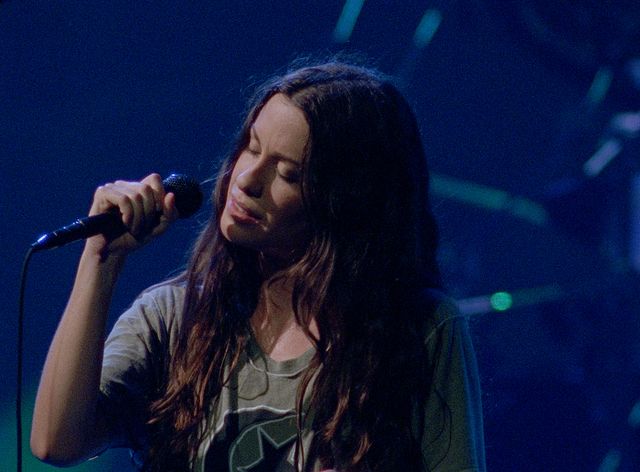 Alanis Morissette performing onstage during the Jagged Little Pill tour in 1996.