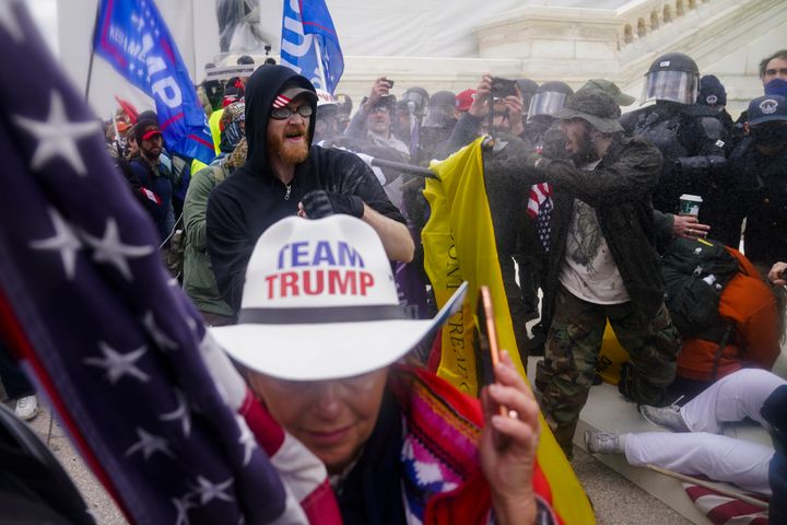 Insurrections loyal to President Donald Trump try to break through a police barrier at the U.S. Capitol on Jan. 6. A federal judge on Monday said a lawsuit claiming the 2020 election was stolen from Trump presented baseless claims that have been used to foment violence.
