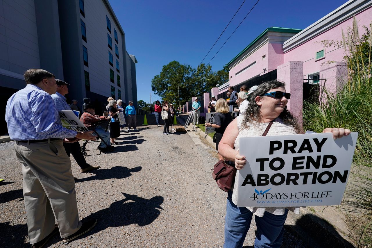 Anti-abortion protesters stand outside the Jackson Women's Health Organization clinic and shut down part of the street on Sept. 22, 2021. 