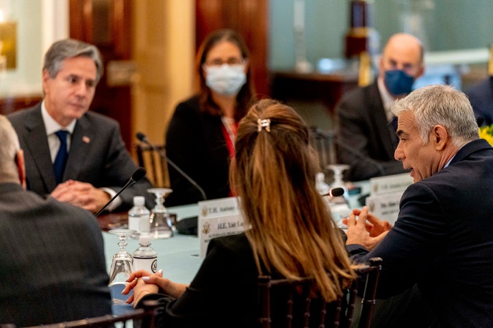 Israeli Foreign Minister Yair Lapid, right, accompanied by Secretary of State Antony Blinken, top left, speaks at a bilateral meeting Oct. 13 at the State Department.