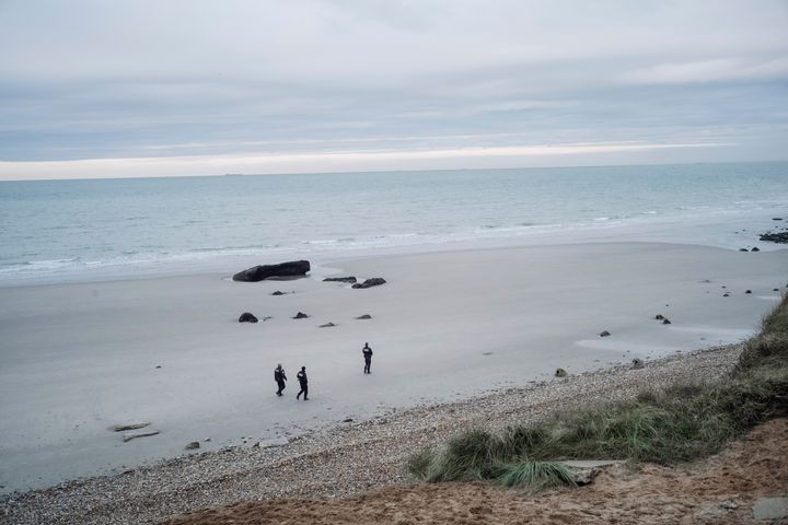 French police officers patrol on the beach in the search for migrants in Wimereux, northern France, on Wednesday. Several migrants died and others were injured when their boat capsized off Calais in the English Channel while trying to reach Britain, authorities said.