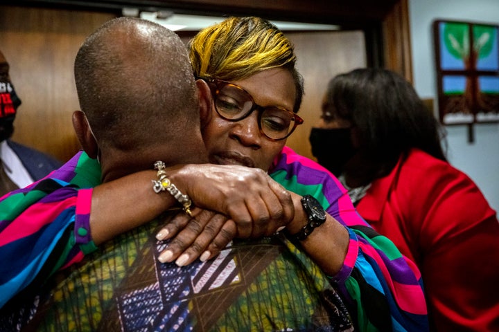 Ahmaud Arbery's mother, Wanda Cooper-Jones, his hugged by a supporter Wednesday after the jury convicted Travis McMichael, his father, Greg McMichael, and neighbor William "Roddie" Bryan in Brunswick, Georgia.