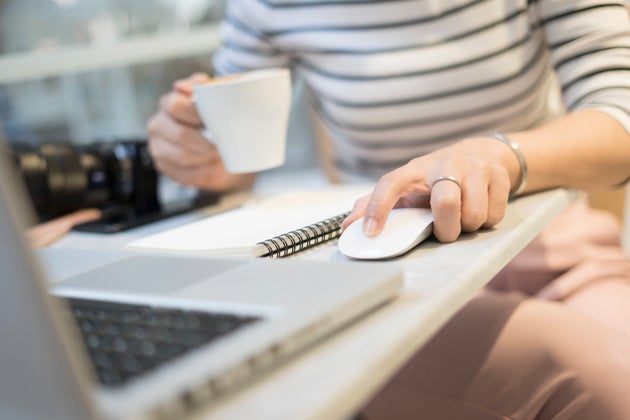 Hand holding computer mouse and Click with keyboard computer with dark background