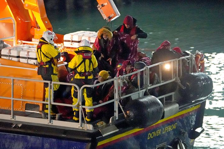A group of people thought to be migrants are brought in to Dover, Kent, by the RNLI on Wednesday