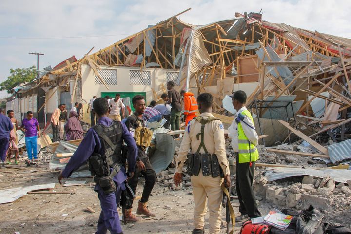 Security forces and rescue workers search for bodies at the scene of a blast in Mogadishu, Somalia, on Nov. 25, 2021.