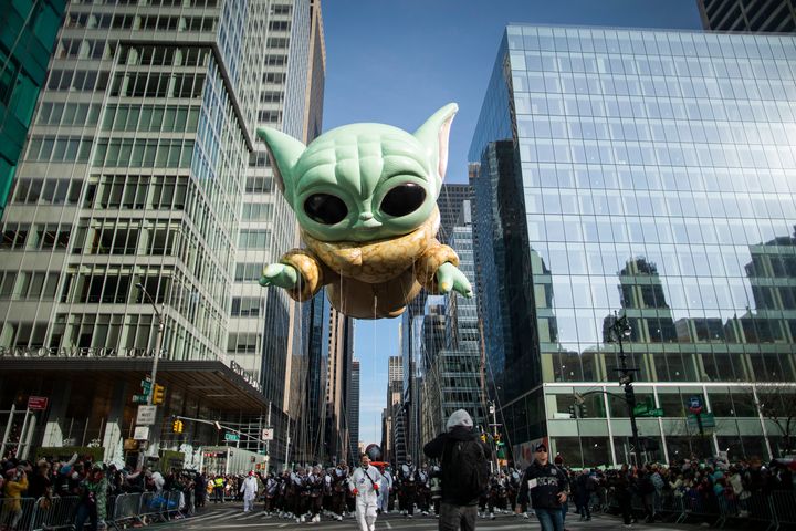 Baby Yoda, also known as the Grogu balloon, floats along 6th Ave. in New York.