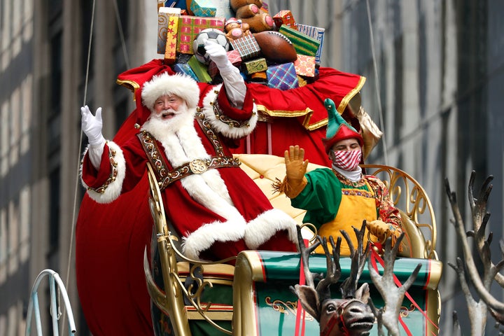 Santa Claus waved at spectators while riding his sleigh in New York City.