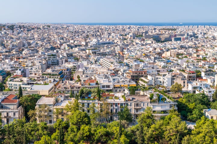 This is an overview of the historical city of Athens, Greece with the Saronic gulf in the background. It is shot from the Acropolis.