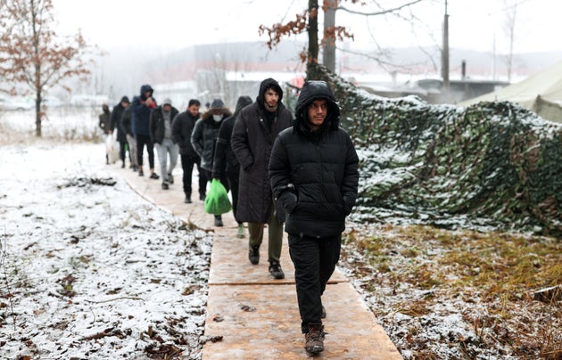 GRODNO REGION, BELARUS  NOVEMBER 27, 2021: Migrants near the Bruzgi transport and logistics centre on the Belarusian-Polish border. The migrant crisis on the border of Belarus with Poland, Lithuania, and Latvia escalated on November 8. Several thousand migrants have approached the Belarusian-Polish border and set up a tent camp there. Sergei Bobylev/TASS (Photo by Sergei Bobylev\TASS via Getty Images)