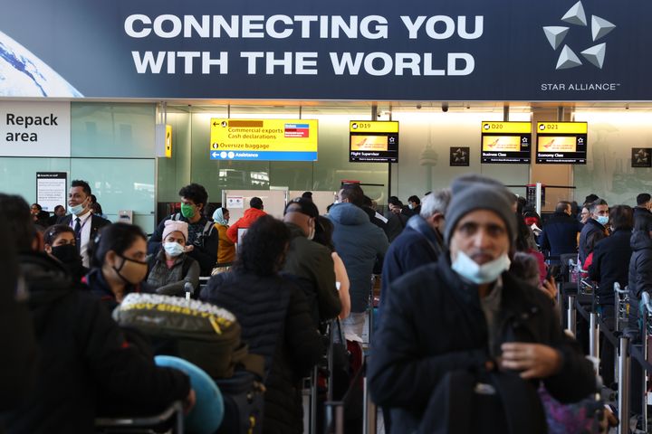Travelers at London's Heathrow Airport on Sunday. The United Kingdom imposed new restrictions on arriving travelers due to the omicron variant.