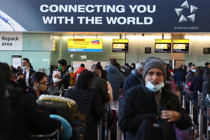 Travelers at London's Heathrow Airport on Sunday. The United Kingdom imposed new restrictions on arriving travelers due to the omicron variant.