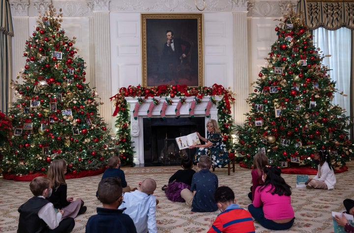 Biden reads to students from Malcolm Elementary School during the unveiling of the holiday decorations Monday.