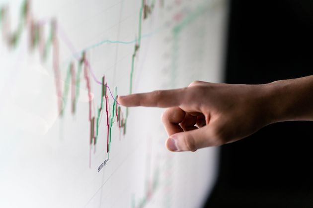 Finger pointing at market analysis with digital