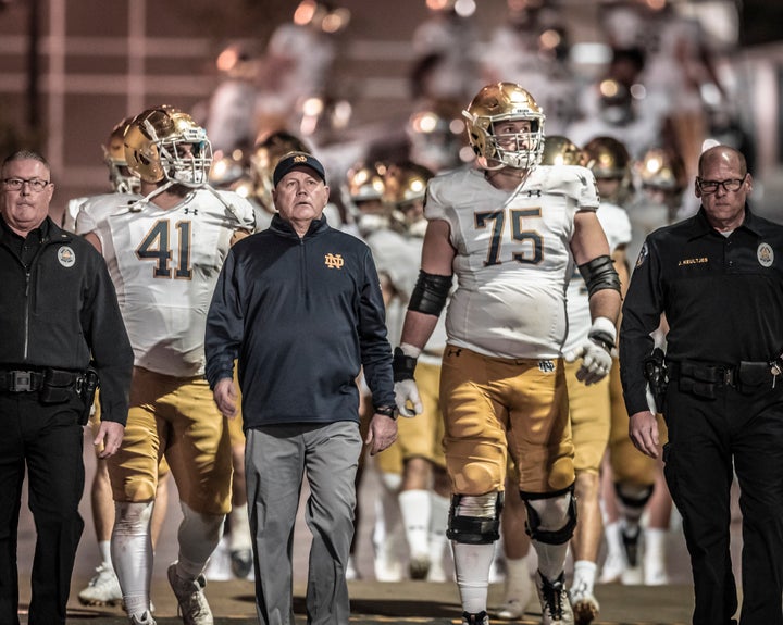 Coach Brian Kelly of the Notre Dame Fighting Irish football team leads his team into the stadium before the second half of an NCAA football game against the Stanford Cardinal on November 27, 2021 at Stanford Stadium.