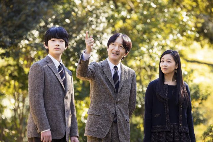 In this photo provided by Imperial Household Agency of Japan, Japan's Crown Prince Akishino, center, strolls with his son Prince Hisahito and his daughter Princess Kako at the garden of their Akasaka imperial property residence in Tokyo on Nov. 12. Akishino celebrates his 56th birthday Tuesday, Nov. 30.