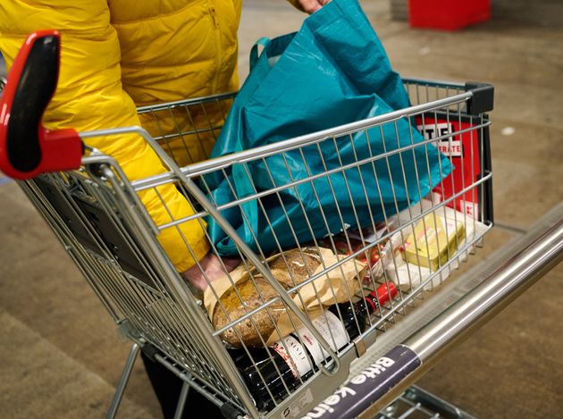 29 November 2021, Berlin: A man puts the groceries he bought into his bag. Inflation jumped in November, hitting the five percent mark for the first time in about 29 years. According to preliminary data from the Federal Statistical Office, consumer prices rose by 5.2 percent compared to the same month last year. Photo: Annette Riedl/dpa (Photo by Annette Riedl/picture alliance via Getty Images)