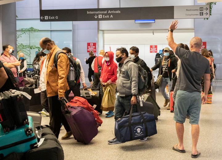 Travelers arrive at the international terminal of San Francisco International Airport on Nov. 8.