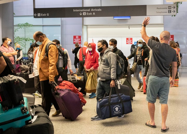 Travelers arrive at the international terminal of San Francisco International Airport on Nov. 8.