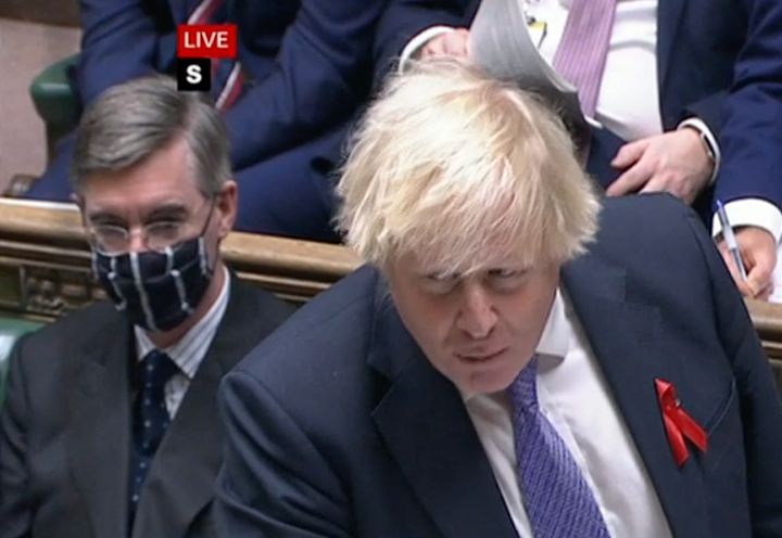 Jacob Rees-Mogg (left) with a mask