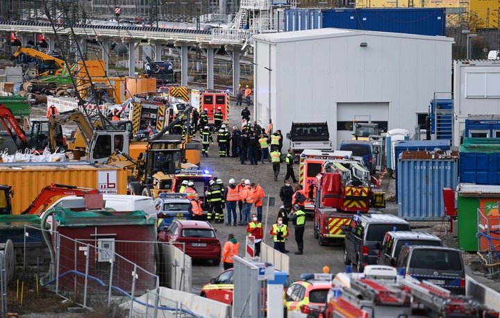 Firefighters, police officers and railway employees are seen at a railway site in Munich, Germany, on Dec. 1, 2021.