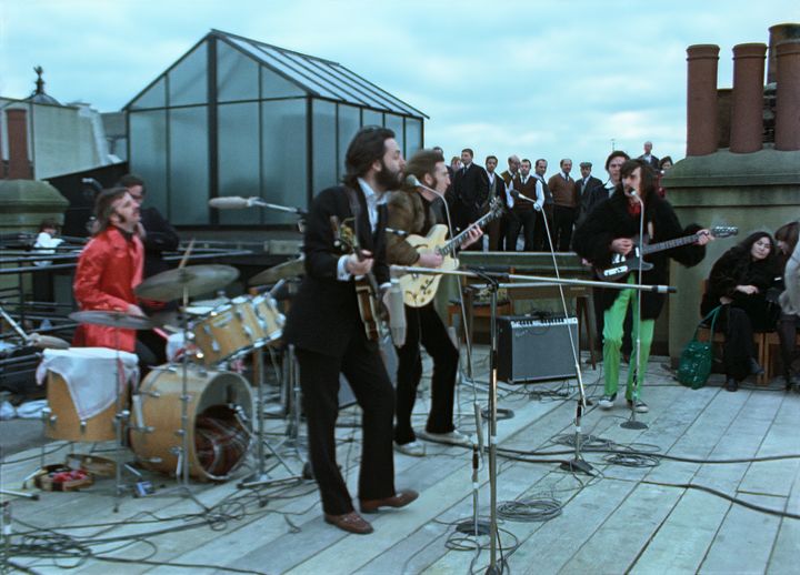 The band plays their famous lunchtime rooftop concert.