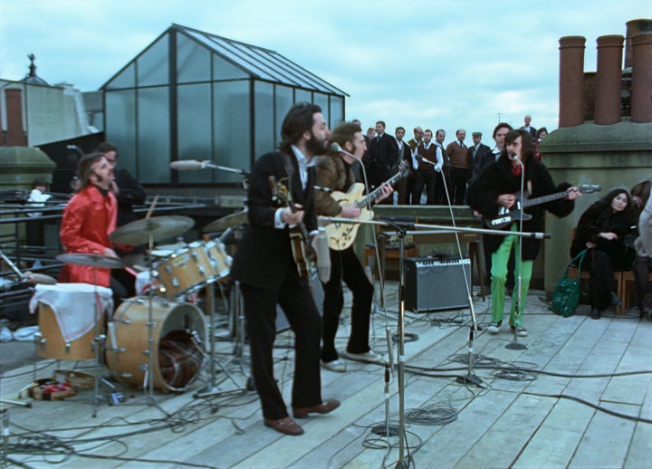 The band plays their famous lunchtime rooftop concert.