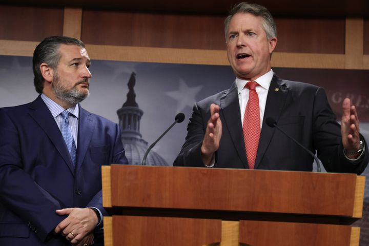 Sen. Ted Cruz (R-Texas) listens as Sen. Roger Marshall (R-Kan.) speaks during a news conference in October. Marshall is part of a group of GOP lawmakers who have pledged to oppose a government funding bill over vaccination requirements outlined by the Biden administration. 