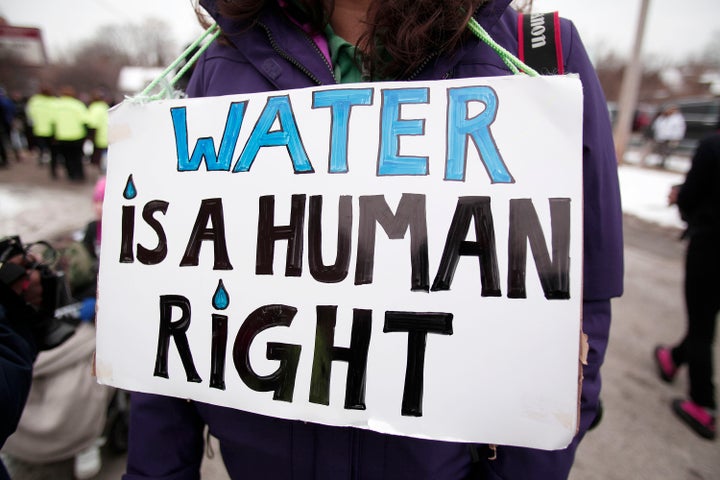 People gather in front of a church before participating in a march to highlight the push for clean water in Flint, Michigan, Feb. 19, 2016.