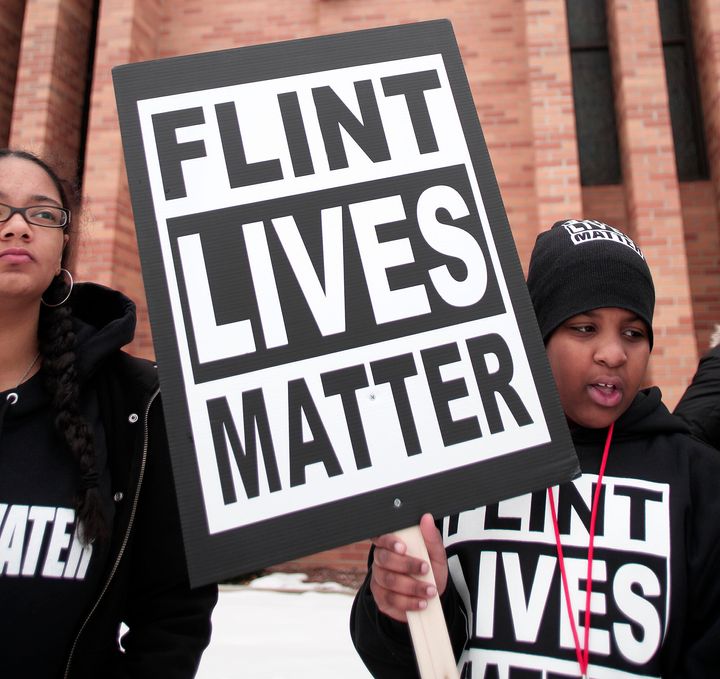 People prepare to participate in a march to highlight the push for clean water in Flint, Feb. 19, 2016.