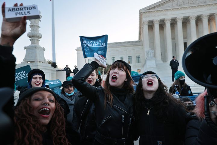 Demonstrators Alana Edmondson, Lila Bonow, Amelia Bonow and Aiyana Knauer celebrate after taking abortion pills while demonstrating in front of the U.S. Supreme Court as the justices hear arguments Wednesday. 