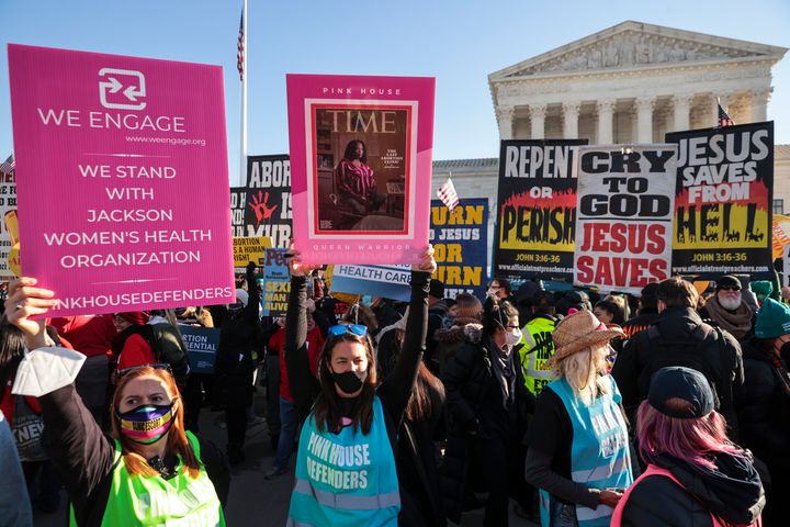 Demonstrators on both sides of the issue gather in front of the Supreme Court as the justices hear arguments Wednesday.