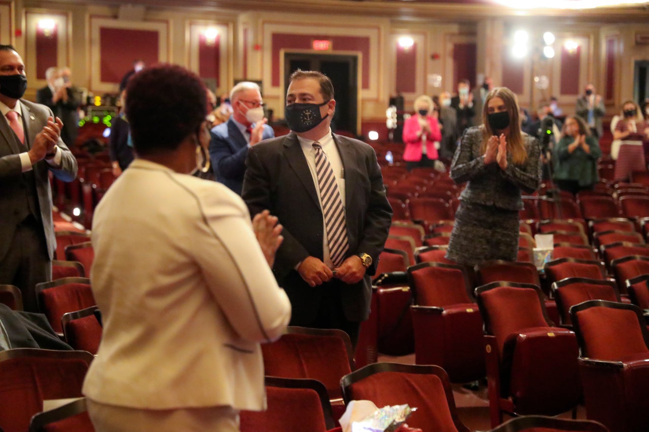 K. Joseph Shekarchi (D), center, is applauded by colleagues after they voted to make him Rhode Island House speaker. Progressives disagree over whether to work with him.