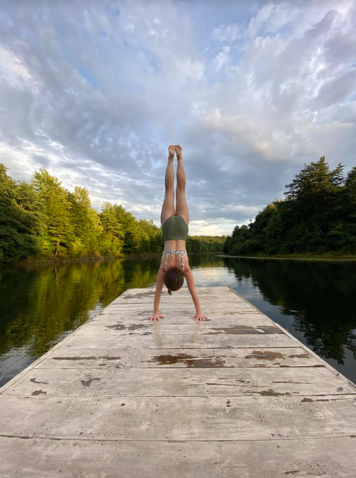The author combining two of her favorite things: handstands and fresh water.