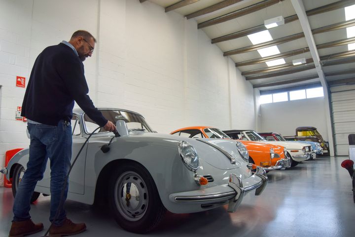 Ο Στιβ Ντράμοντ, συνιδρυτής της Electrogenic, που μετατρέπει τα κλασικά αυτοκίνητα με κινητήρες εσωτερικής καύσης σε ηλεκτρικά, φορτίζει μια Porsche.