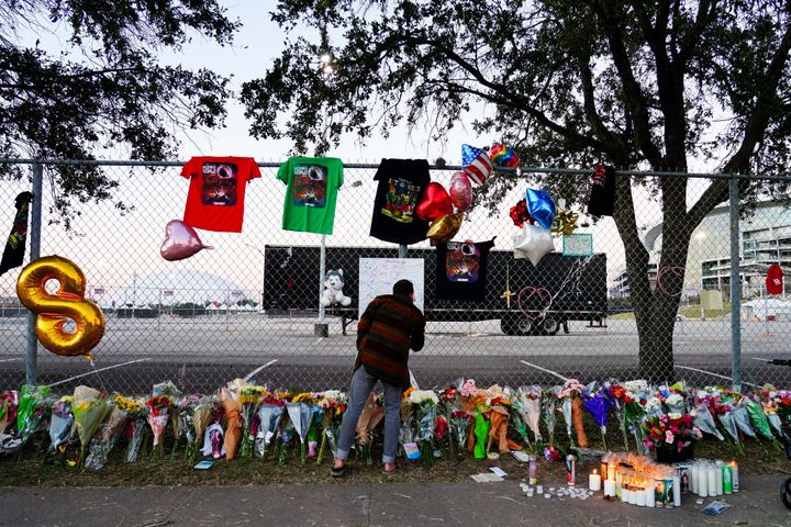 A visitor writes a note at a memorial outside of the canceled Astroworld festival at NRG Park in Houston, Texas. 