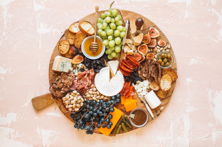 In this charcuterie board designed by Elizabeth Van Lierde, there's a feeling of abundance, but space for guests to cut, drizzle and easily serve themselves.