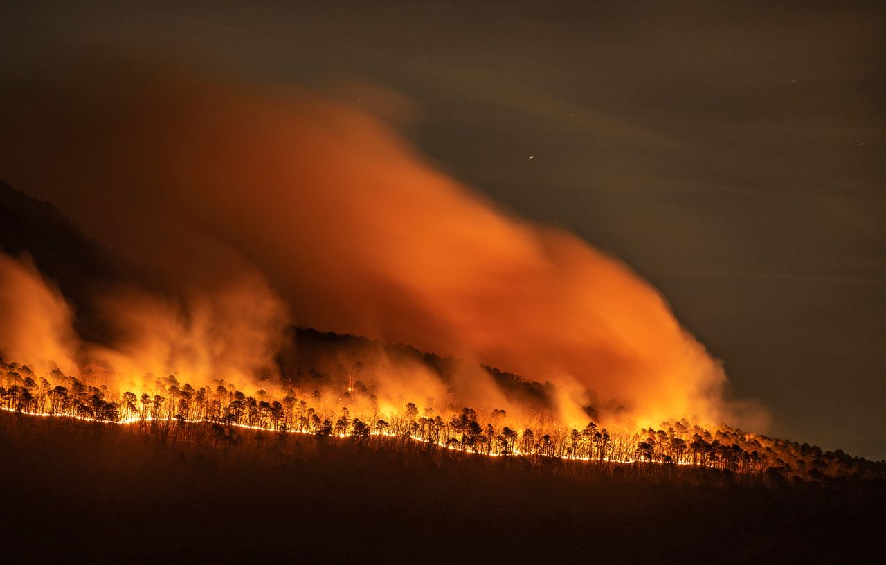 Fire burns along the western ridge of Pilot Mountain in North Carolina on Monday. The fire, which was reported to have started Saturday night, had burned more than 500 acres as of Monday night.