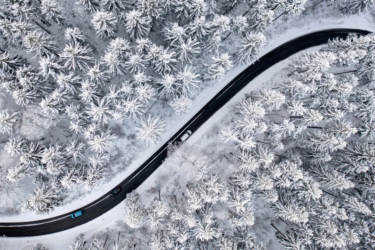 In this photo taken Thursday with a drone, a road stretches through the snow-covered Thuringian Forest in Ilmenau, Germany.