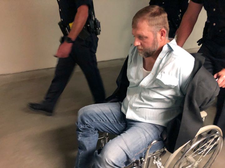 Ammon Bundy is rolled out of the Idaho Statehouse in Boise, Idaho, in a wheelchair on Aug. 26, 2020, following his arrest for trespassing.