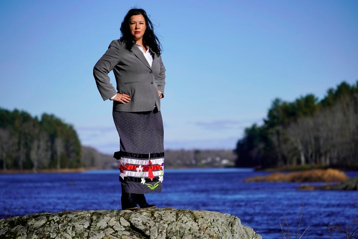 Dawn Neptune Adams stands on the banks of the Penobscot River on Indian Island, Maine. When Adams was a child, she was one of the many Penobscot and Passamaquoddy people who were removed from their homes by the state of Maine and placed with white foster families.