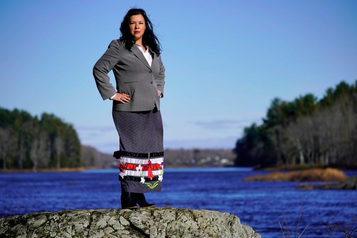 Dawn Neptune Adams stands on the banks of the Penobscot River on Indian Island, Maine. When Adams was a child, she was one of the many Penobscot and Passamaquoddy people who were removed from their homes by the state of Maine and placed with white foster families. 